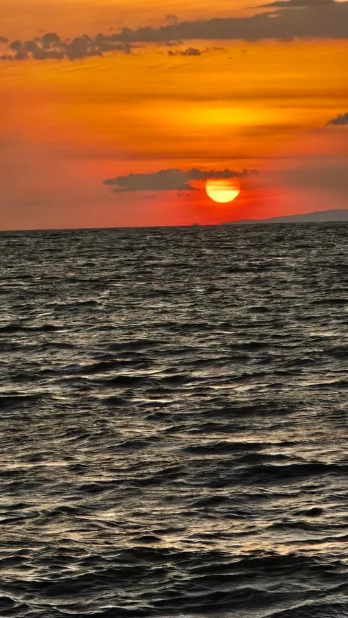 Orange sunset over Lake Victoria in Kisumu, with the sun setting on the water