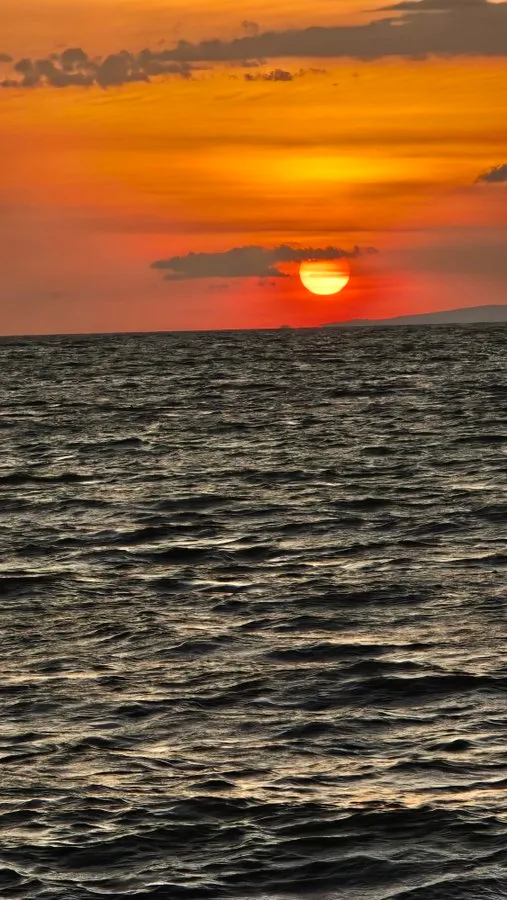Orange sunset over Lake Victoria in Kisumu, with the sun setting on the water